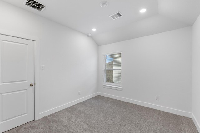 carpeted spare room with recessed lighting, visible vents, lofted ceiling, and baseboards