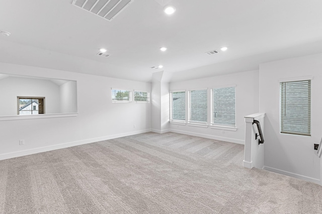 unfurnished room with light carpet, visible vents, recessed lighting, and baseboards