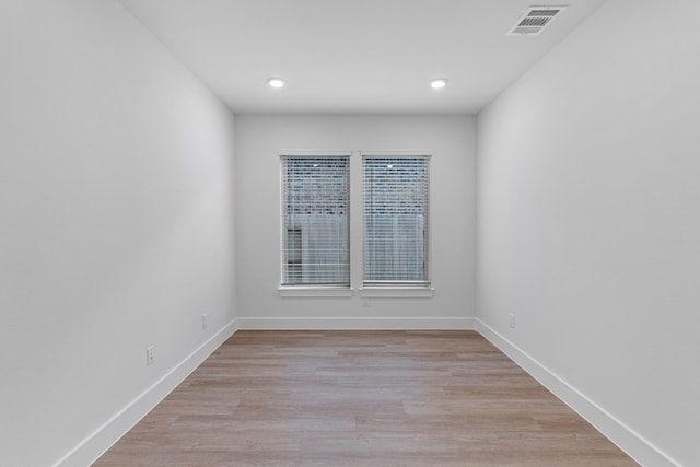 spare room with recessed lighting, baseboards, visible vents, and light wood finished floors