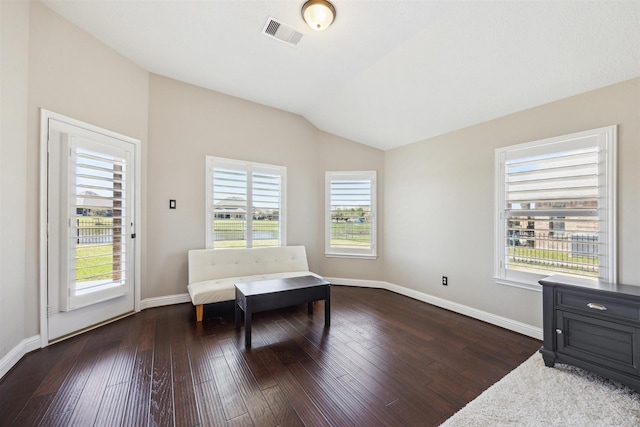 living area featuring lofted ceiling, baseboards, visible vents, and dark wood-style flooring