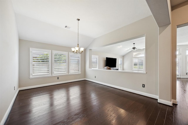 unfurnished living room with visible vents, a healthy amount of sunlight, dark wood-style flooring, and vaulted ceiling