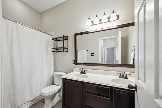 full bathroom with double vanity, toilet, and a sink