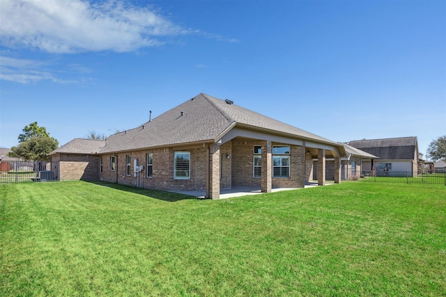 back of house with a patio, fence, a lawn, and brick siding