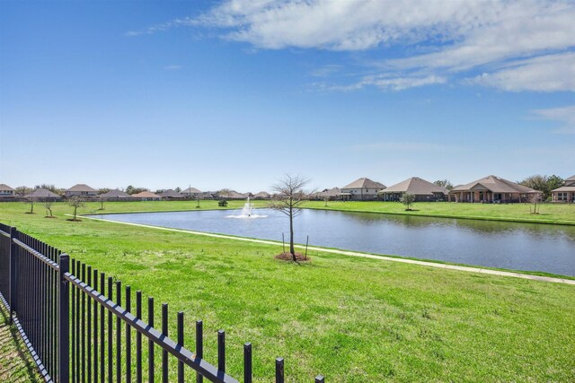 water view with a residential view and fence