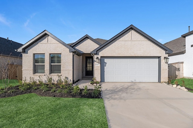 view of front facade featuring driveway, fence, a front yard, a garage, and brick siding