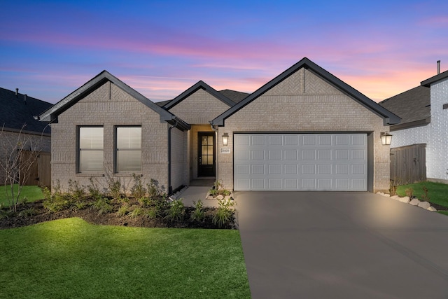 view of front facade with an attached garage, driveway, a front lawn, and fence