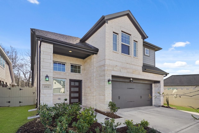 view of front facade with fence, roof with shingles, a garage, stone siding, and driveway