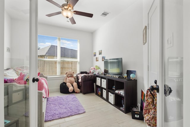 recreation room with visible vents, a ceiling fan, and light wood-type flooring