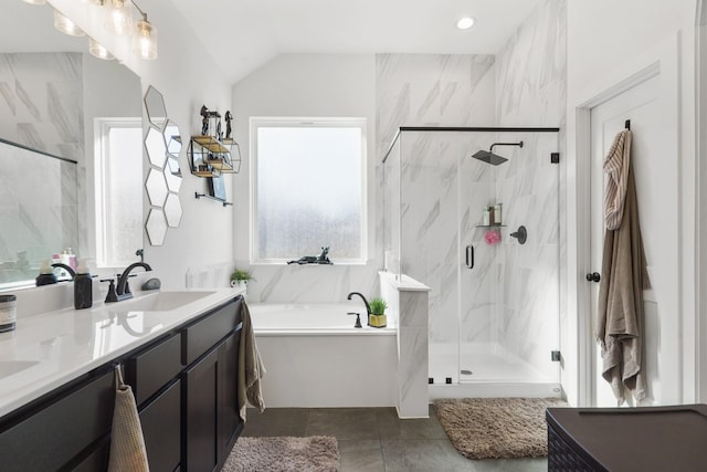 bathroom with a marble finish shower, lofted ceiling, double vanity, a garden tub, and a sink