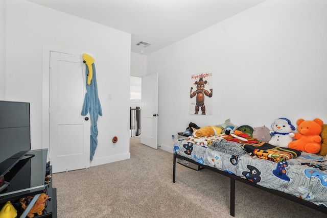 carpeted bedroom featuring visible vents and baseboards