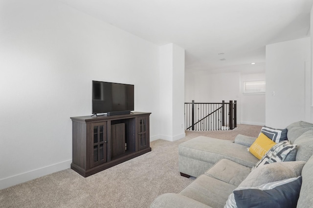 carpeted living area featuring recessed lighting and baseboards