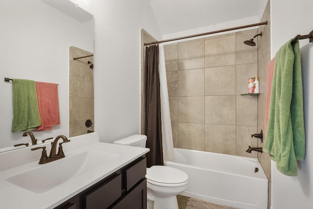 bathroom featuring toilet, shower / bath combo with shower curtain, and vanity