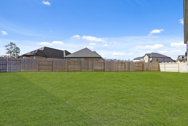 view of yard with a fenced backyard