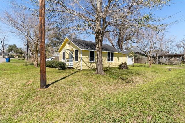 exterior space featuring a front lawn and fence