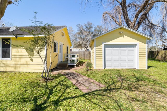 detached garage with driveway and fence