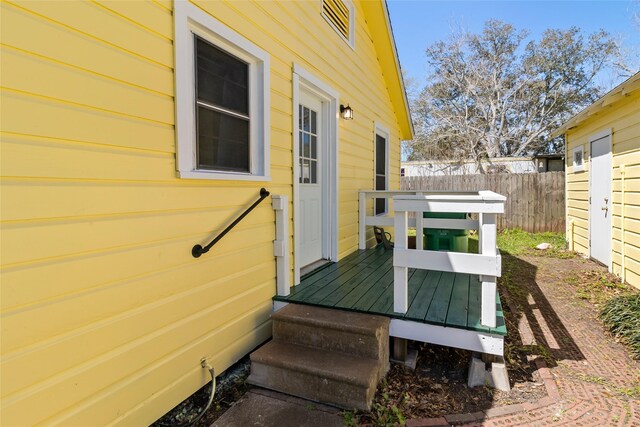 wooden terrace with a garage and fence