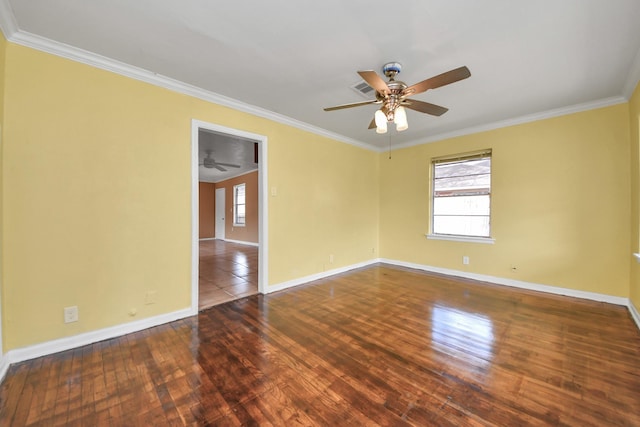 spare room featuring ornamental molding, baseboards, and hardwood / wood-style floors