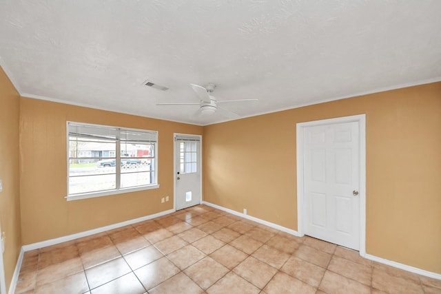 unfurnished room featuring light tile patterned floors, visible vents, baseboards, and ceiling fan