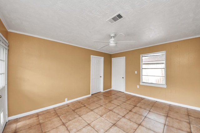 empty room featuring visible vents, crown molding, baseboards, ceiling fan, and a textured ceiling