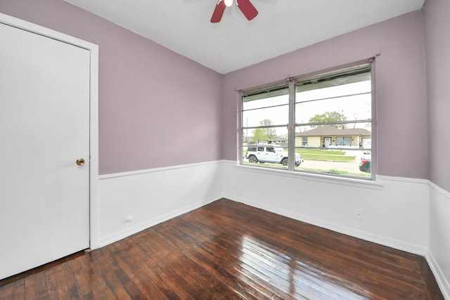 empty room with dark wood-type flooring and ceiling fan