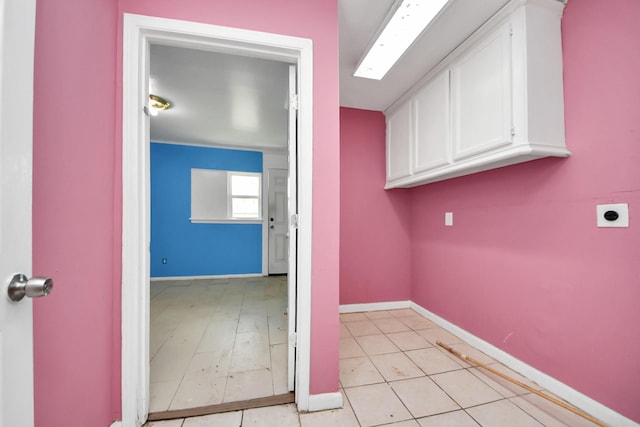 clothes washing area with cabinet space, baseboards, and hookup for an electric dryer