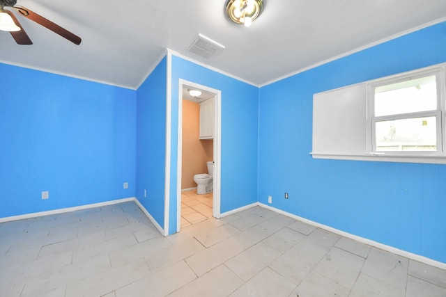 unfurnished bedroom featuring visible vents, ensuite bath, crown molding, and baseboards