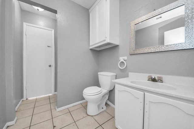 bathroom with tile patterned floors, visible vents, toilet, baseboards, and vanity