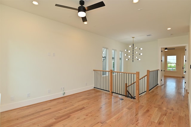 empty room featuring light wood finished floors, visible vents, baseboards, recessed lighting, and a ceiling fan