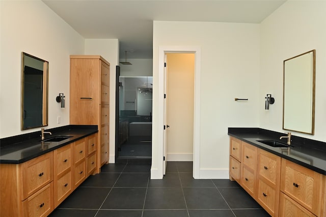 bathroom featuring tile patterned floors, two vanities, a stall shower, and a sink