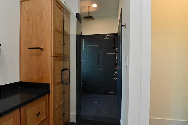 full bath with a stall shower, vanity, and tile patterned flooring