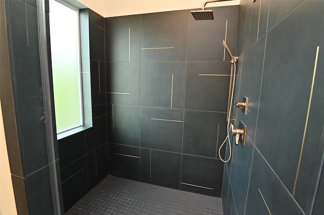 bathroom with a wealth of natural light and a tile shower