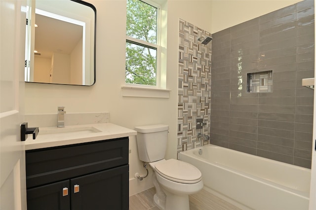 bathroom with bathing tub / shower combination, toilet, and vanity