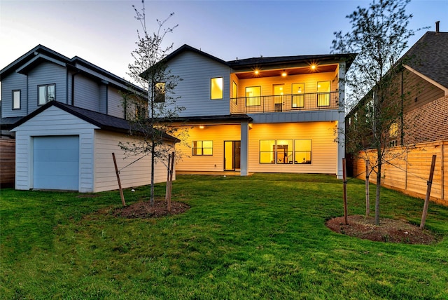 rear view of house featuring a lawn, a ceiling fan, a balcony, and fence