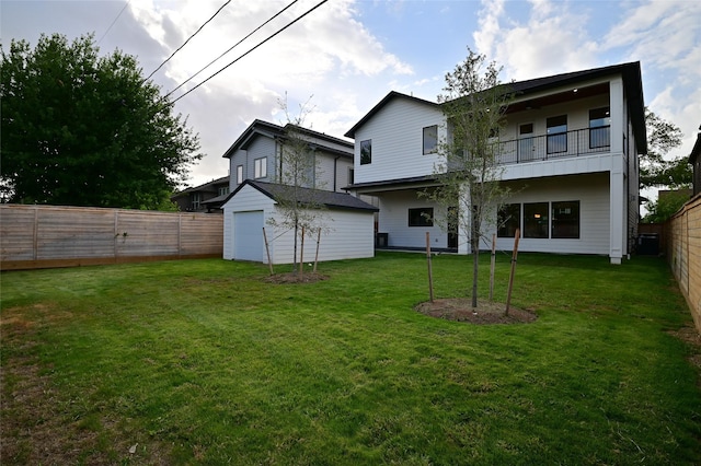 back of house with a balcony, a yard, and a fenced backyard