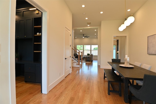 dining space featuring visible vents, baseboards, stairs, recessed lighting, and light wood-style floors