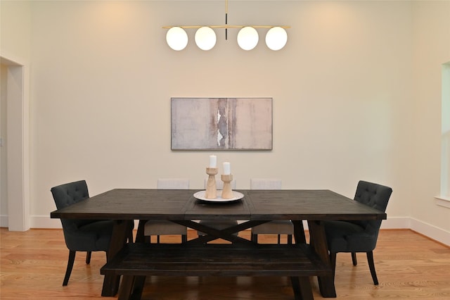 dining room with baseboards and light wood-style flooring