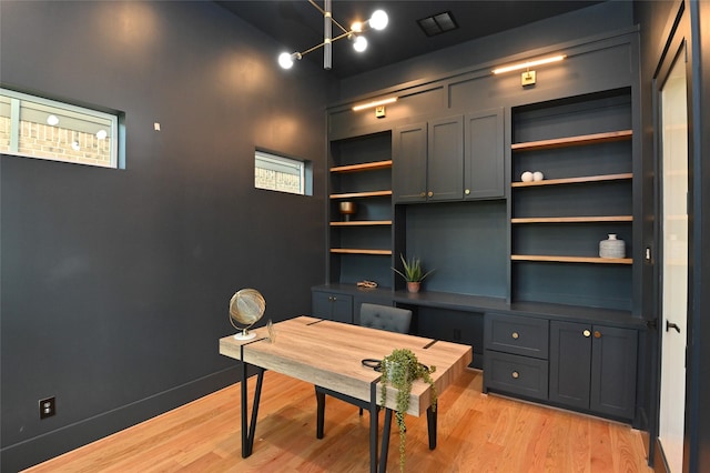 office space featuring light wood-type flooring and baseboards