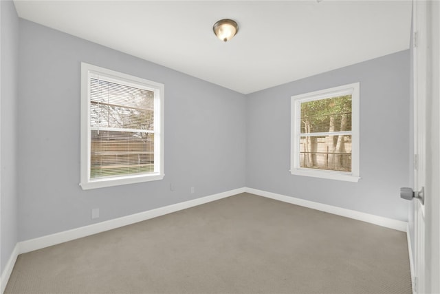 unfurnished room featuring baseboards and carpet floors