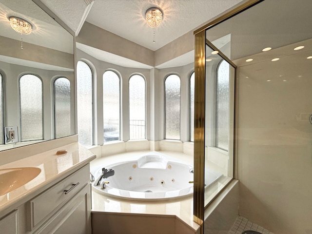 bathroom featuring vanity, a shower stall, a whirlpool tub, and a textured ceiling