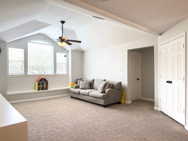 carpeted living room featuring visible vents, a textured ceiling, ceiling fan, and vaulted ceiling