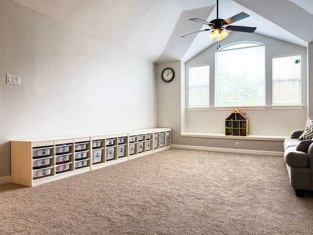 unfurnished room with baseboards, lofted ceiling, carpet, and a textured ceiling