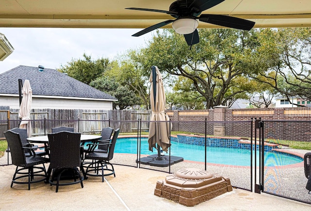 view of pool with outdoor dining space, a ceiling fan, a fenced in pool, a fenced backyard, and a patio area