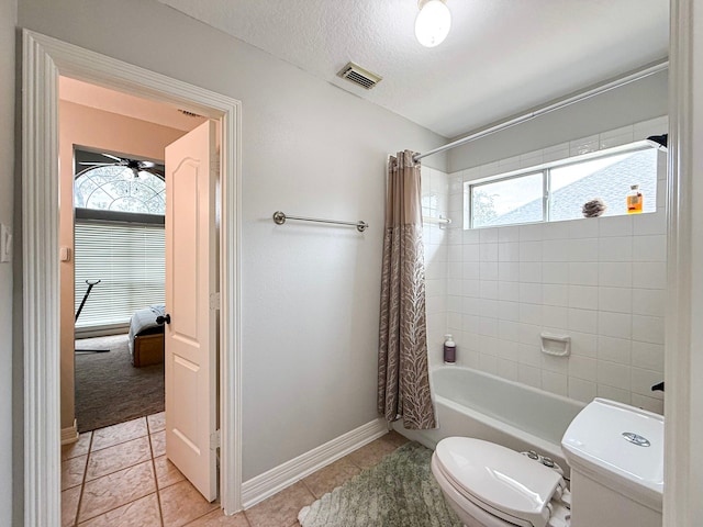 full bath featuring visible vents, plenty of natural light, toilet, and a textured ceiling