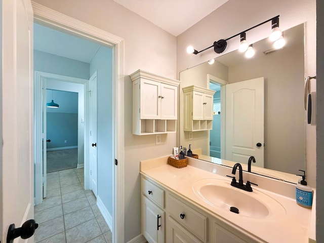 bathroom featuring baseboards, vanity, and tile patterned flooring