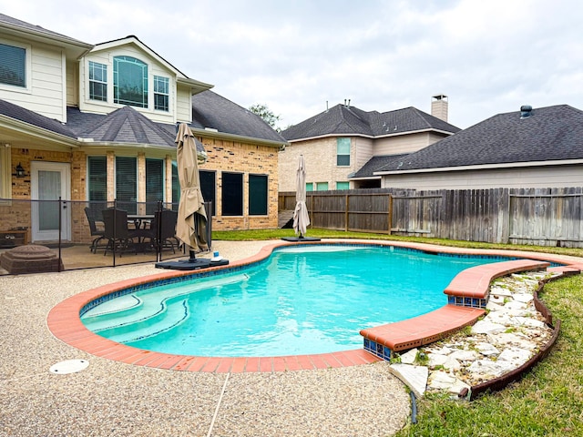 view of swimming pool with a patio area, a fenced backyard, and a fenced in pool