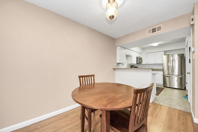 10555 Turtlewood Ct Unit 1510, Houston, TX 77072 - dining room with light wood finished floors, baseboards, and visible vents