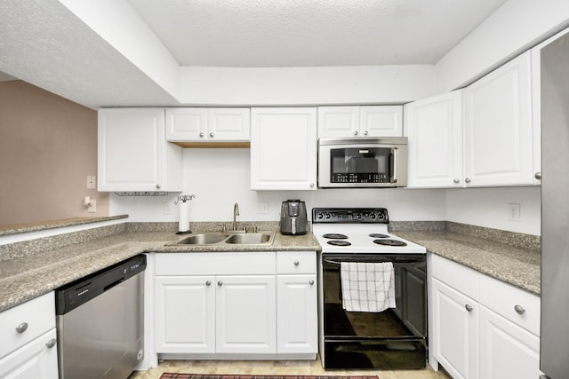 10555 Turtlewood Ct Unit 1510, Houston, TX 77072 - kitchen featuring a sink, white cabinets, appliances with stainless steel finishes, and a textured ceiling