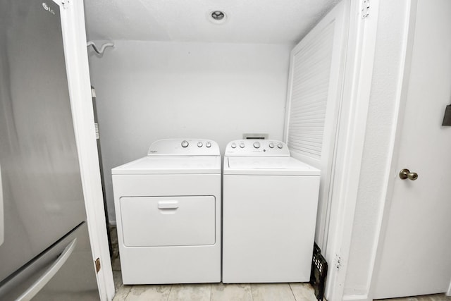 10555 Turtlewood Ct Unit 1510, Houston, TX 77072 - clothes washing area with washer and clothes dryer and laundry area