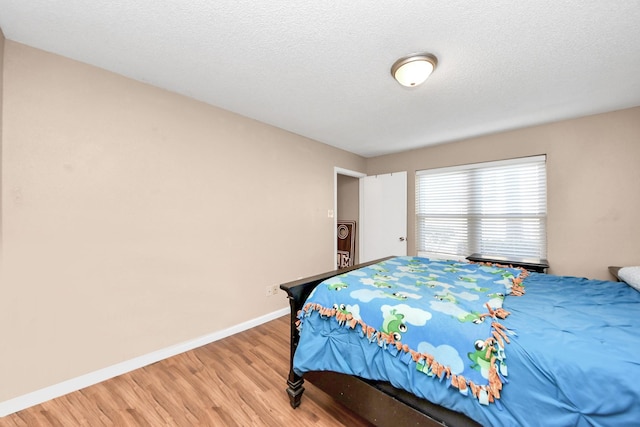 10555 Turtlewood Ct Unit 1510, Houston, TX 77072 - bedroom with baseboards and light wood-style floors