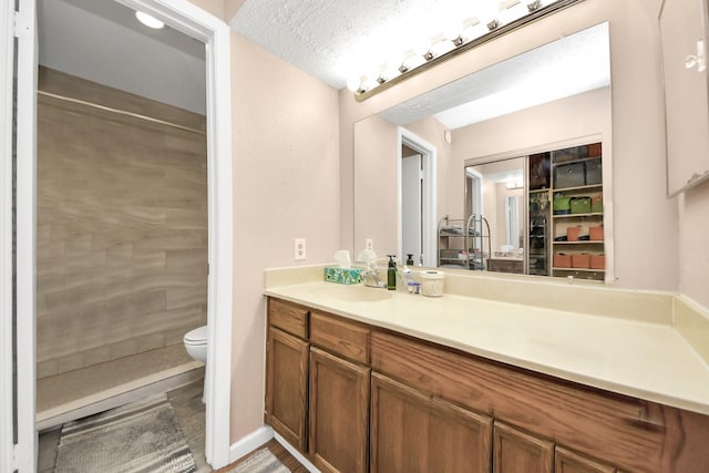 10555 Turtlewood Ct Unit 1510, Houston, TX 77072 - bathroom with toilet, tiled shower, and vanity